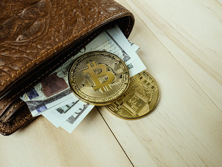 bitcoin in Crocodile leather wallet  on  wood table.