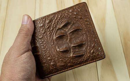 Crocodile leather wallet on  wood table.の写真素材