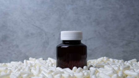 Medicine bottle  and white capsules image  for  sci or medical content.の写真素材