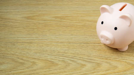 piggy bank on wood table for  Finance or saving money business content.の写真素材