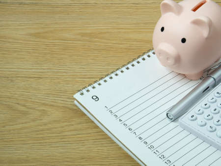 piggy bank on wood table for  Finance or saving money business content.の写真素材
