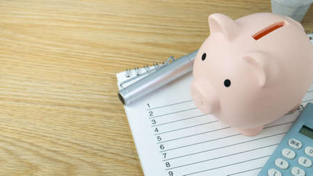 piggy bank and blue calculator for saving money or business  conceptの写真素材