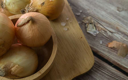 onions on wood table for food or cooking concept.の写真素材