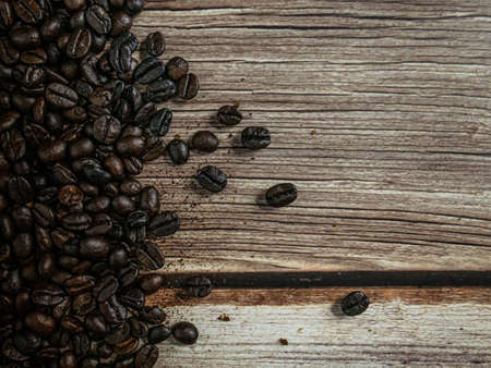 coffee beans on wood table for hot drink or coffee concept.の写真素材