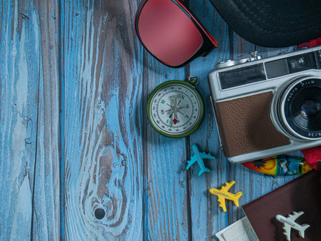 camera and passport on wood table for travel concept.の写真素材