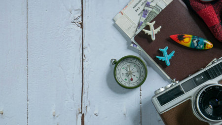 camera and passport on wood table for travel concept.
