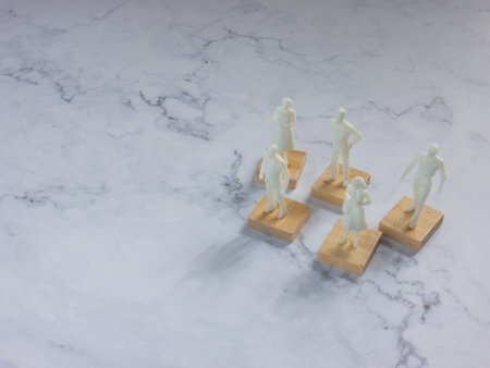 The plastic  figure business man on whit marble for teamwork concept