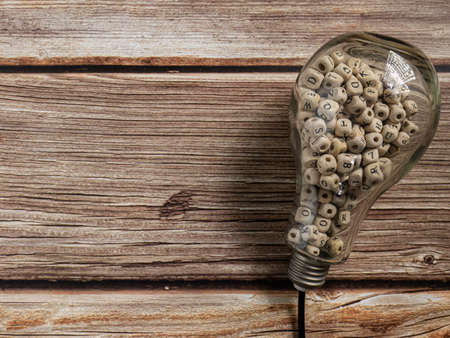 light bulb and alphabet wood cube on wood table  for idea or think conceptの写真素材