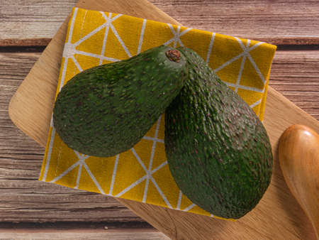The  avocado on wood table top view image for food concept.の写真素材