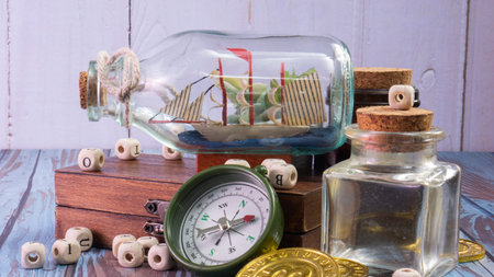 The boat in  bottle on wood table for travel or transport concept
