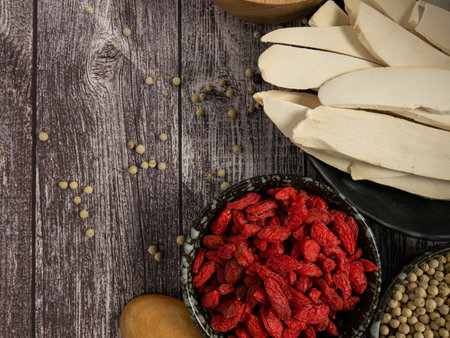 Chinese yam or san yao and goji berry on wood table for food conceptの写真素材