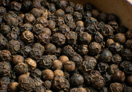 Black pepper corn on wood table for food conceptの写真素材