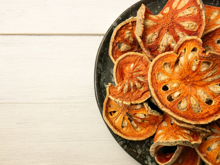 The bael fruit, also known as "wood apple," is a tropical fruit native to India and commonly found in Southeast Asia. It comes from the Bael tree.の写真素材