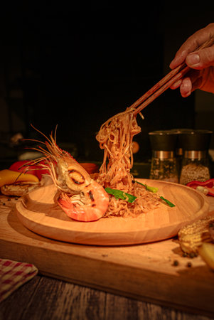 Prawn Pad Thai on wood plate for Food concept.の写真素材