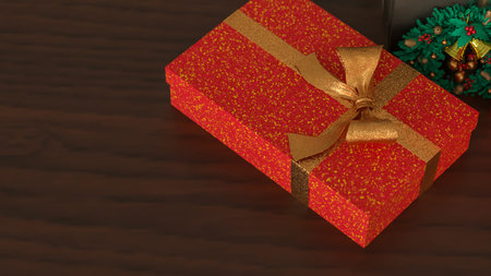 Festive Christmas gift boxes with golden ribbons and a small wreath on wooden table, creating a warm...