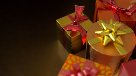 Luxury gift boxes wrapped in gold and red with decorative bows, symbolizing celebration, Christmas, holiday season, birthday, festive presents, and elegant gift giving.の写真素材