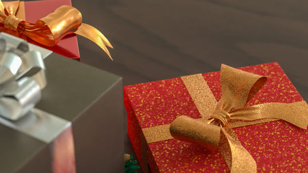 Festive Christmas gift boxes with golden ribbons and a small wreath on wooden table, creating a warm...