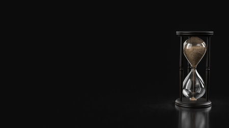 Classic hourglass with flowing sand on a dark background, symbolizing time passing, patience, deadlines, life balance, and minimalist time management themes.の写真素材