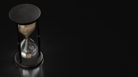 Classic hourglass with flowing sand on a dark background, symbolizing time passing, patience, deadlines, life balance, and minimalist time management themes.の写真素材