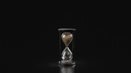 Classic hourglass with flowing sand on a dark background, symbolizing time passing, patience, deadlines, life balance, and minimalist time management themes.の写真素材