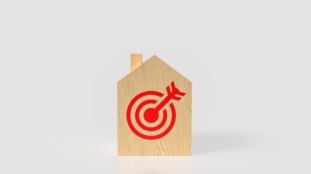 Wooden house block with a red target and arrow symbolizing real estate goals, property investment...