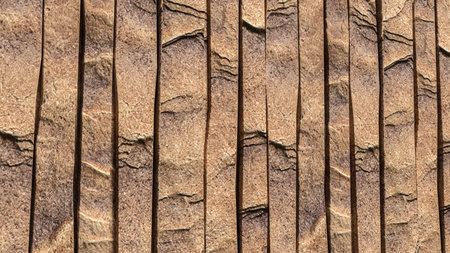 Natural brown stone wall texture with vertical panel pattern for exterior interior design...