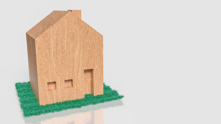 wooden house model on green grass isolated on white background representing real estate property housing investment home ownership and residential development conceptの写真素材