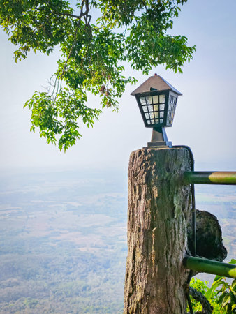 Lantern mounted on a cement wooden post overlooking mountain scenery. Perfect for architecture,...