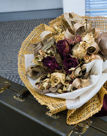 dry rose bouquet with suitcaseの写真素材