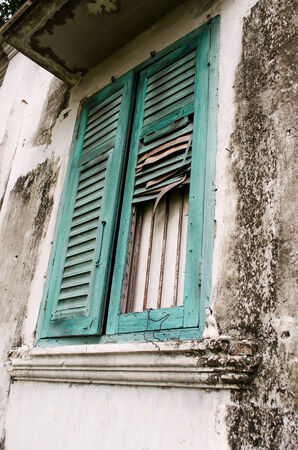 old broken window with woman statue beckoning happy lotの写真素材