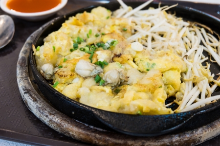 Fried Oyster Cakes served on iron hot plate  Fried Oyster Omelette の写真素材