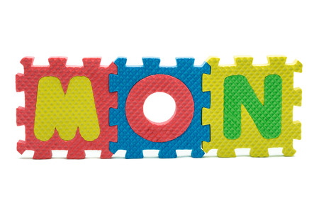 word MON formed with colorful foam puzzle toy isolated on white blackgroundの写真素材
