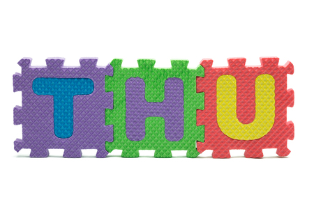 word THU formed with colorful foam puzzle toy isolated on white blackgroundの写真素材