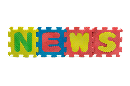 word NEWS formed with colorful foam puzzle toy isolated on white blackgroundの写真素材