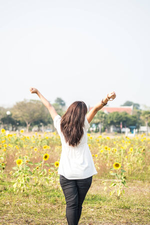 asian girl in the sunflower fieldの写真素材