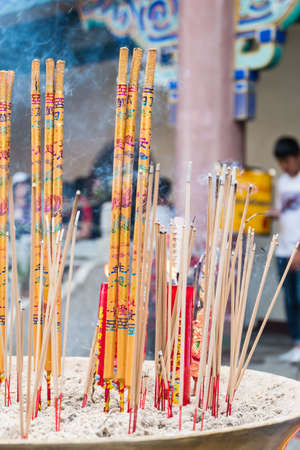 Joss sticks burn at an altar in chinese templeのeditorial素材
