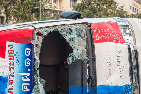 BANGKOK-FEB 22: Car damaged and broken, Thai police clash with anti-government protesters at...