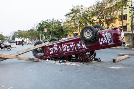 BANGKOK-FEB 22  Police Car damaged and broken, Thai police clash with anti-government protesters at Democracy-monument, Ratchadamnoen Road on February 22, 2014 in Bangkok, Thailandのeditorial素材