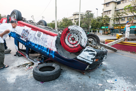 BANGKOK-FEB 22  Police Car damaged and broken, Thai police clash with anti-government protesters at Democracy-monument, Ratchadamnoen Road on February 22, 2014 in Bangkok, Thailandのeditorial素材