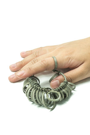 hand with Jeweler finger sizing toolsの写真素材