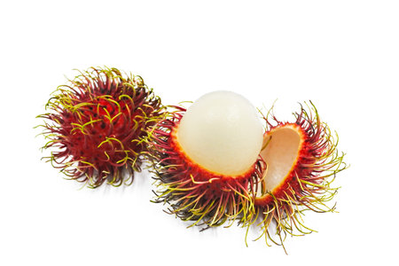 Thai fruits rambutan cut halved on white background.の写真素材