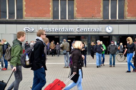 Tourists and local people are travelling in front of Amsterdam central, Netherlandsのeditorial素材