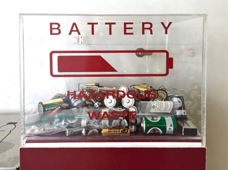 Box for hazardous waste provided by the street near the exit of environmental friendly building in...