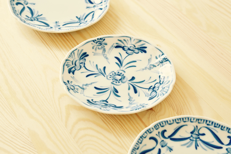 Vintage style blue and white plates on the cupboard at homeの写真素材