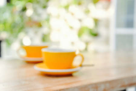 Coffee in orange cup for two background defocusの写真素材