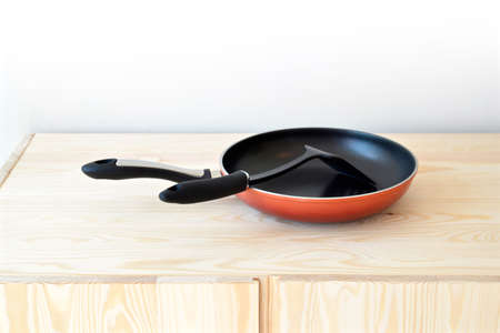 Red pan  on the cupboard at home.の写真素材