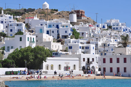Many people are relaxing at the beach along Mykonos waterfront, Greece.のeditorial素材