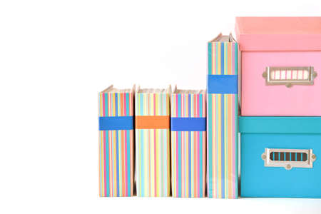 Colorful binders and boxes with blank label on white backgroundの写真素材