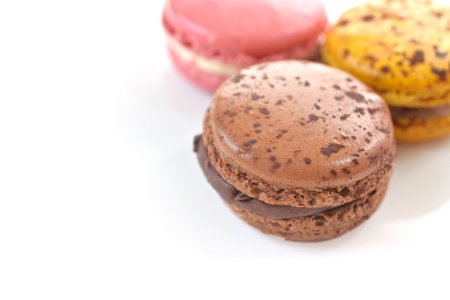 Chocolate, rose and passion fruit macaroon on white backgroundの写真素材