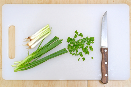 Cut spring onion on cutting board with knife, Thailandの写真素材